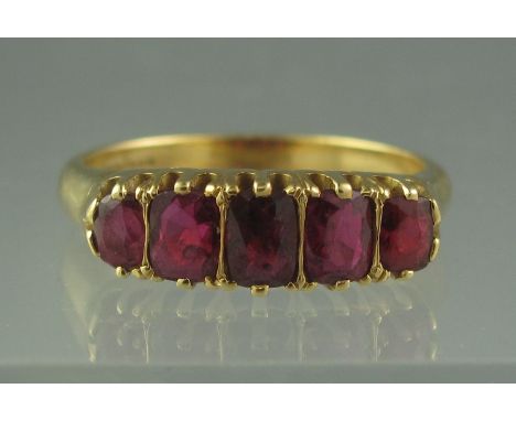 18CT GOLD FIVE STONE RUBY RING. Graduated rectangular rubies are claw set, centre stone approx 5 x 4mm, ring size K, weight 5