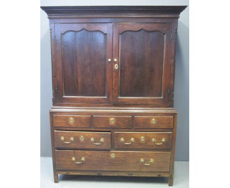 19TH CENTURY WELSH OAK LINEN PRESS CUPBOARD having moulded dental cornice above two blind panelled ogee fielded doors, the in