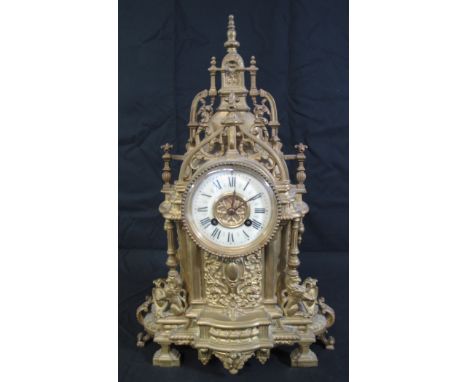 19TH CENTURY FRENCH YELLOW METAL GOTHIC DESIGN STEEPLE SHAPED MANTEL CLOCK having ceramic face with Roman numerals and French