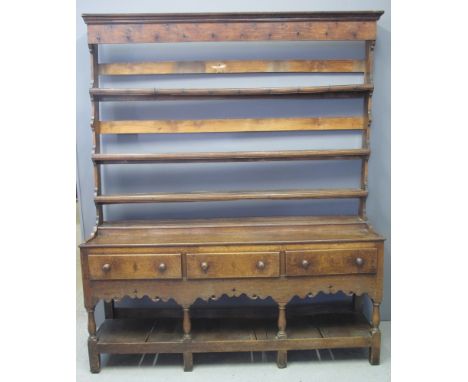 LATE 18TH/EARLY 19TH CENTURY WELSH OAK POT BOARD DRESSER having open three shelf rack back with shaped ends over step, the ba