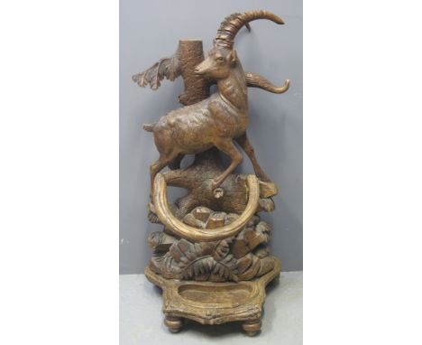 LATE 19TH/EARLY 20TH CENTURY CARVED BLACK FOREST STICK STAND in the form of an Ibex on a naturalistic and foliate base (incom