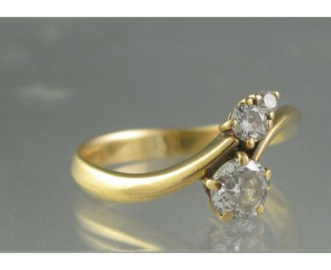 DIAMOND CROSSOVER RING set with three brilliant cut diamonds. Estimated total diamond weight 0.65cts, Ring size R, Weight 4.1