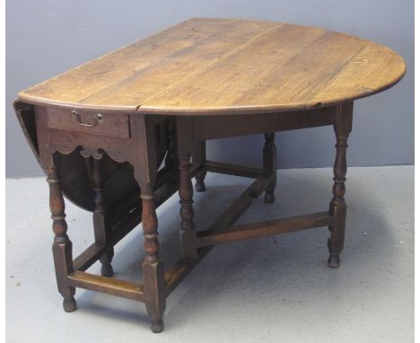 18TH CENTURY OAK OVAL GATE LEG DROP LEAF DINING TABLE on baluster turned supports with single drawer to one end above fret cu