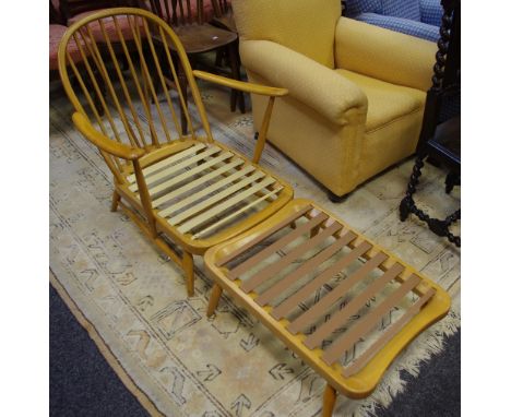 An Ercol type low Windsor model number 203 with conforming foot stool