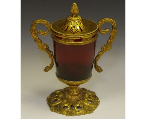 A 19th century French gilt-metal mounted ruby glass vase and cover, cylinder reservoir, scrolling twin-handles cast with frui