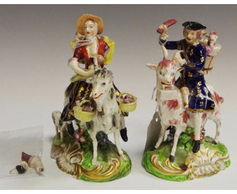 A pair of  Derby figures, The Welsh Tailor and Wife, he seated astride a  goat, he wearing a tricorn hat with a pannier on hi