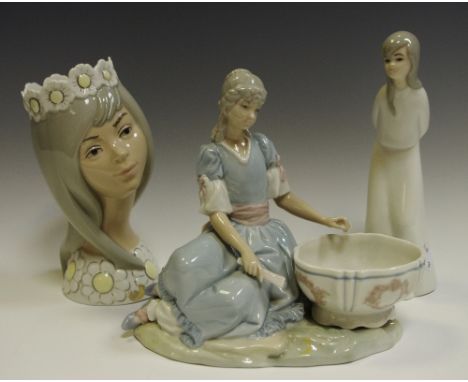A Lladro figure of a lady with wash bowl; two Miguel figures (3)