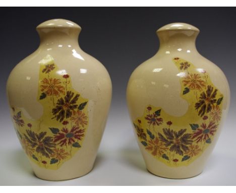 A pair of Denby prototype ovoid table lamp bases, part decorated in an unreleased design of flowers within a shaped asymmetri