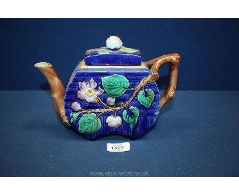 A Majolica Teapot with floral decoration, (damaged).