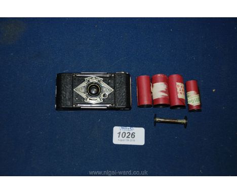 A Houghton Butcher Ensign Midget Camera with five exposed rolls of film