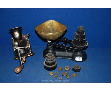 A black cast iron coffee grinder and a set of black Salter balance scales with imperial and metric weights
