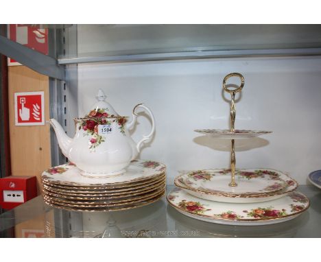 A Royal Albert 'Old Country Roses' pattern teapot, bread and butter plate, cake plate, cake stand and eight dinner plates