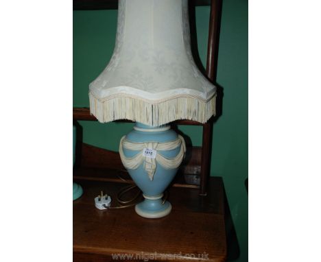 A blue and ivory bedside table lamp with shade