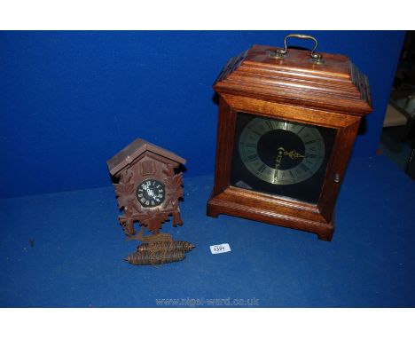 A wooden Cuckoo Clock, a/f and a large wooden framed modern clock with Roman numerals.