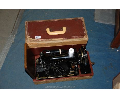 A cased electric Singer sewing Machine, model no. EM 724199