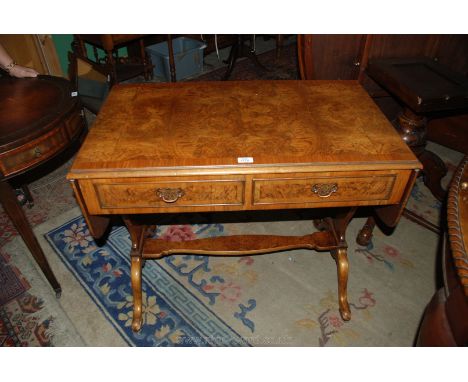 An older reproduction Sofa Table in Mahogany and Walnut having a pair of frieze drawers on elegant supports united by a low s