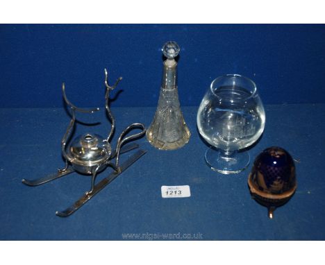 A small box containing a silver mounted scent bottle, brandy glass warmer, ceramic egg stand of Russian type