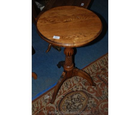 A contemporary light Oak Occasional Table having a circular top, 17'' diameter and standing on a turned support with lattice 