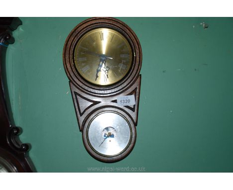 A small wooden hanging clock and thermometer
