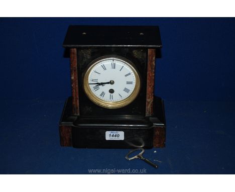 A black Mantle Clock having Roman numerals with key