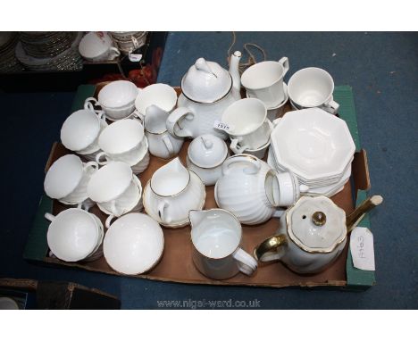 Eleven Wedgwood swirl Cups and saucers, two cream jugs, sugar bowl, Royal Worcester white and gold teapot, milk jug and sugar