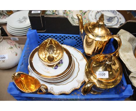 A Royal Winton gold coloured teapot, coffee pot, milk jug and sugar bowl, a Crown Devon fluted plate, etc