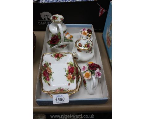 A quantity of Royal Albert 'Old Country Roses' items to include a miniature teapot, swan, posy baskets and various other item