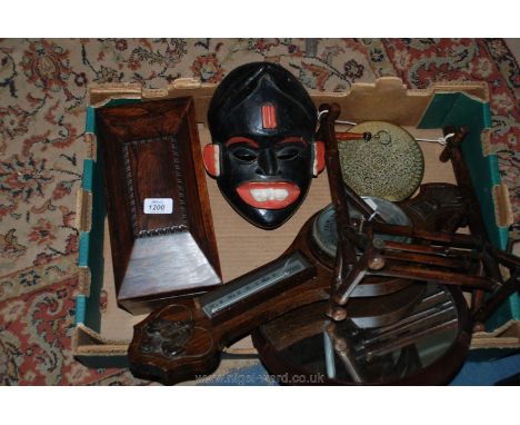 A box of miscellaneous wood items including a Rosewood tea caddy, Chinese gong and beater, Aneroid barometer, etc