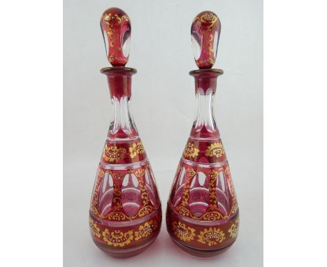 A pair of late 19th century Bohemian gilt and ruby flashed glass decanters, with prism cut decoration, probably made for Pers
