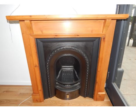 A cast iron fireplace with pine surround. H. 112cm W. 107cm