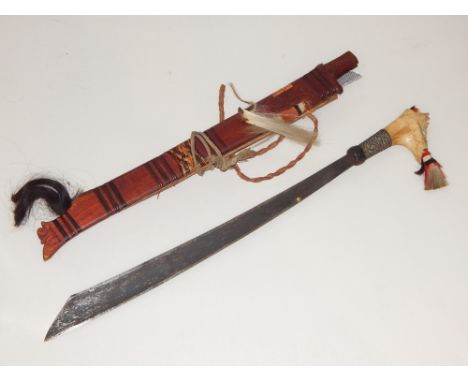 An Indonesian dagger, with bone handle and bamboo scabbard.