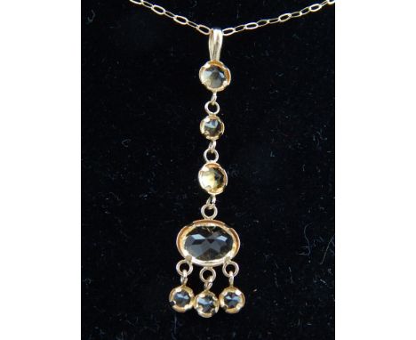 A 9ct yellow gold and citrine drop pendant, suspended on a 9ct yellow gold chain. 
