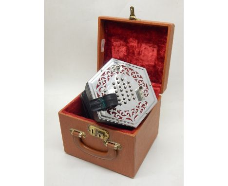 A late 20th century accordion by Wheatstone, with pierced chrome plates, in a tan cloth case.