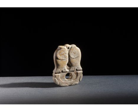Chinese Art Jade pendantChina, Ming dynasty (?). . Cm 4,00 x 5,50. A white calcified yellow dotted jade carving, depicting tw