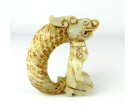 A Chinese white jade group of a kneeling figure with dragon, 10cm high.