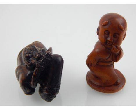 A carved hardwood netsuke, modelled as an immortal, the base bearing a signature, 4.5 cm, together with another netsuke model