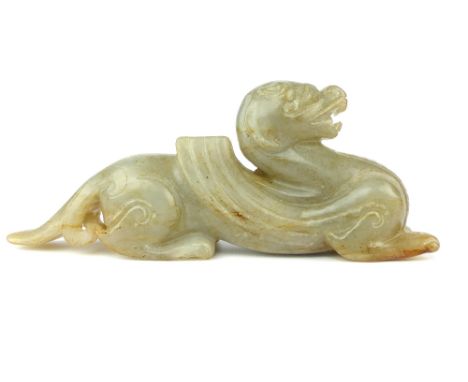 A Chinese carved white / grey jade figure of a winged mythical beast, 17cm long.