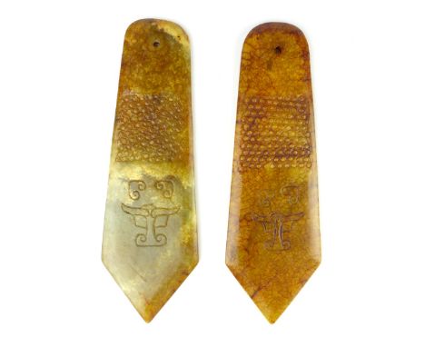 Two Chinese carved jade dagger form court officials' pendants, both 23cm long. (2)