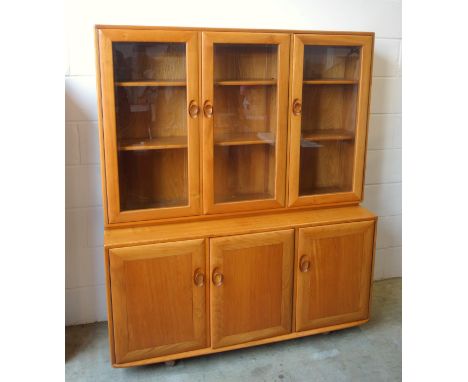 Ercol light elm side cabinet with 3 glazed panelled doors above and 3 panelled doors below, on shepherd castors, 161.5 x 136.