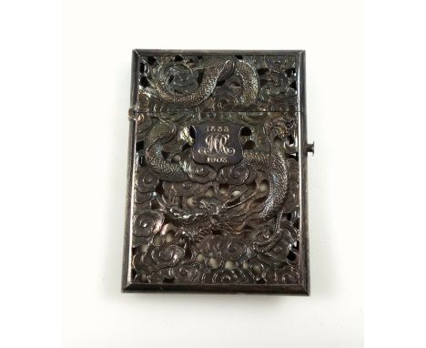 Early 20th Century Chinese silver card case, pieced, chased, and embossed with celestial dragons amidst clouds, and a shield 