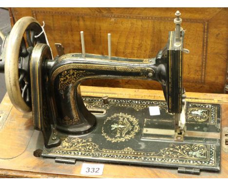 Victorian/Edwardian hand sewing machine with mother of pearl inlay ornate gape with handle inlaid wood design. Not available 