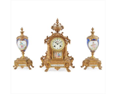 FRENCH GILT METAL AND PORCELAIN THREE-PIECE CLOCK GARNITURE 19TH CENTURY with an urn finial above cornucopia mounts and a cre