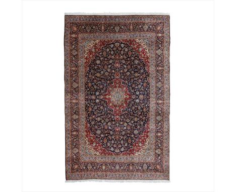 KASHAN CARPET CENTRAL PERSIA, MODERN the indigo field with elongated red, cream and light blue medallion, similar spandrels, 