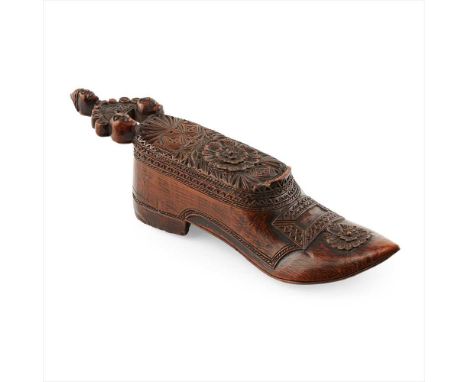 CARVED COQUILLA NUT SHOE-FORM SNUFF BOX EARLY 19TH CENTURY the arched handle carved with three masks, with an oblong cover de