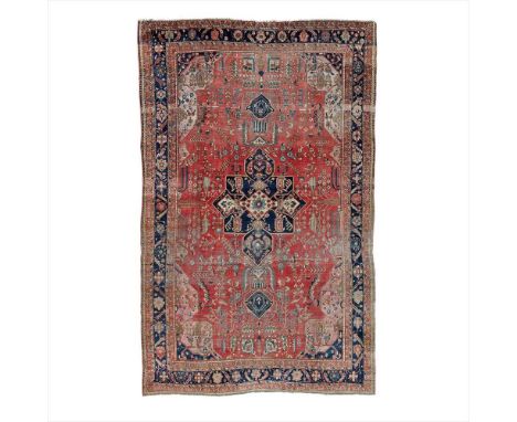SAROUK FEREGHAN CARPET WEST PERSIA, LATE 19TH/EARLY 20TH CENTURY the light red field with indigo medallion, pink and indigo s
