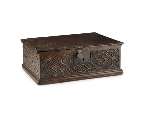 JAMES I OAK BIBLE BOX EARLY 17TH CENTURY the hinged rectangular lid with a central lock opening to a void interior, the front