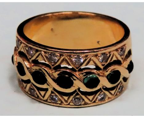 18ct (750) gold ring set with seven small jade coloured stones and small clear stones. Total weight 8.7g

Reasonable used con