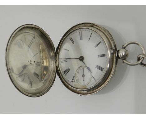 A silver full hunter pocket watch, with engine turned design, the white dial with Roman numerals and subsidiary dial with Ara