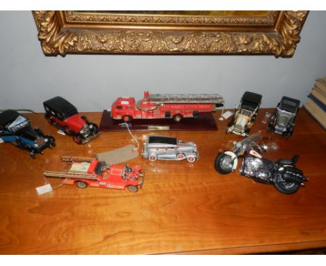 A Franklin Mint scale model of an American LeFrance fire truck, raised on a plinth base, W. 41cm, together with seven further