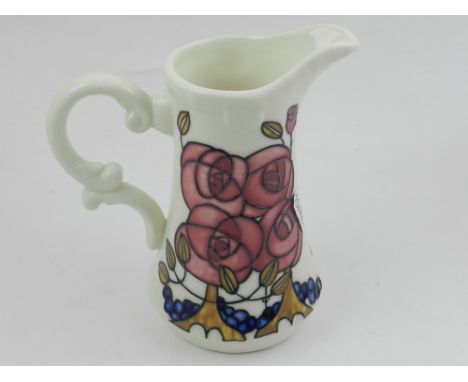 A ceramic vase, in the style of Rene Macintosh, polychrome decorated.